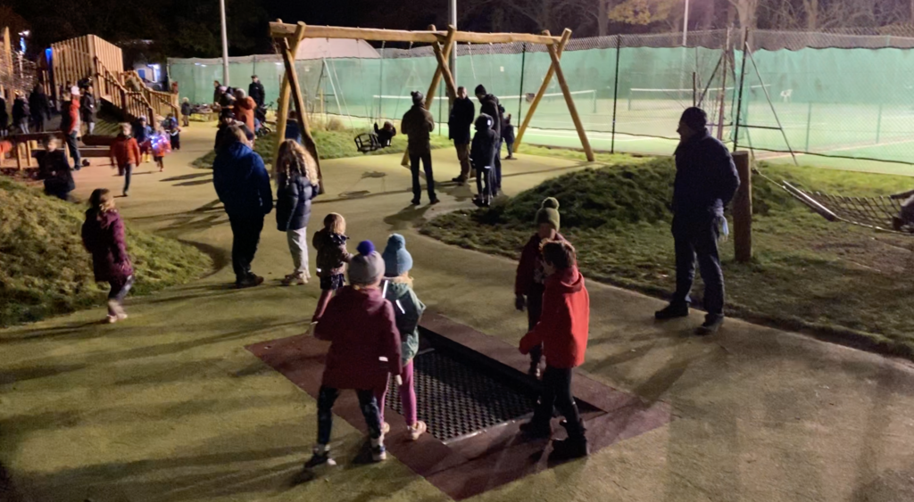 children playing in the lit playscape